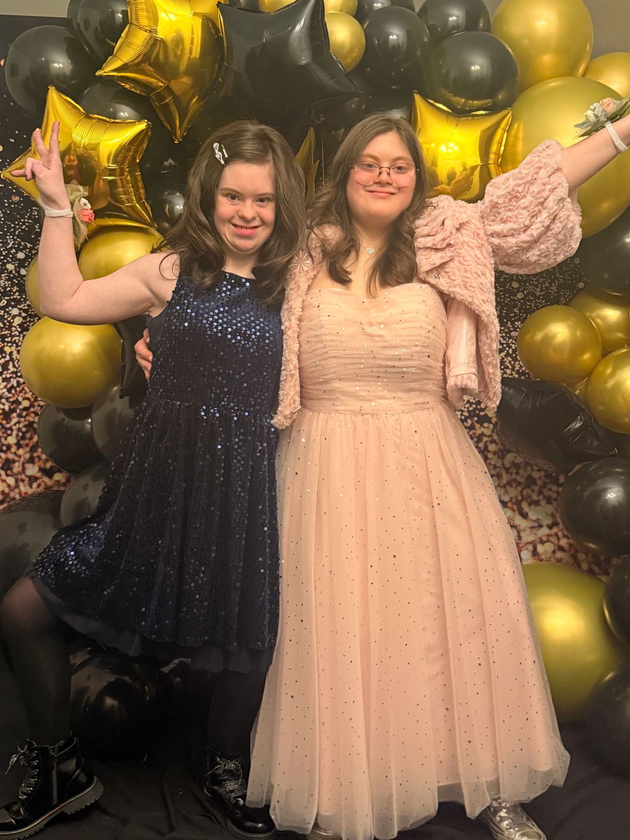 Two young women from The Be Yourself Group dressed up and celebrating